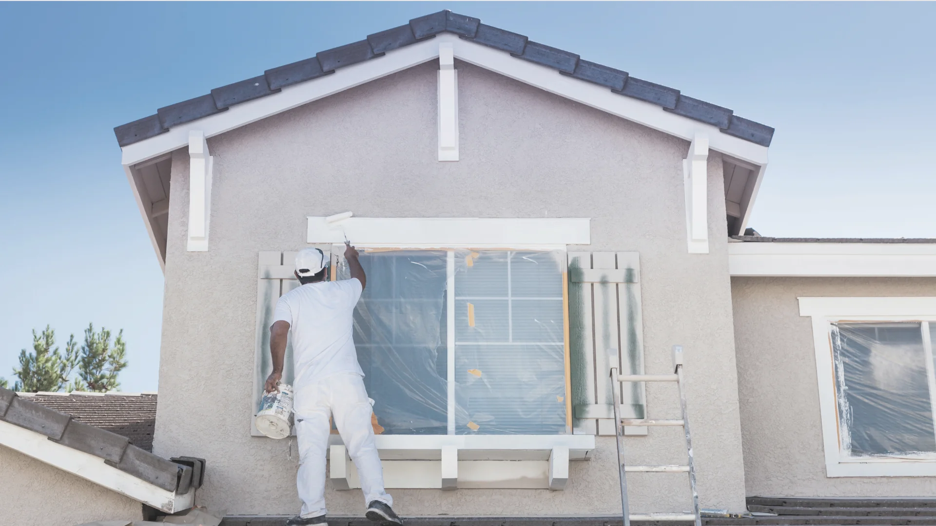 painter painting the outside of a house